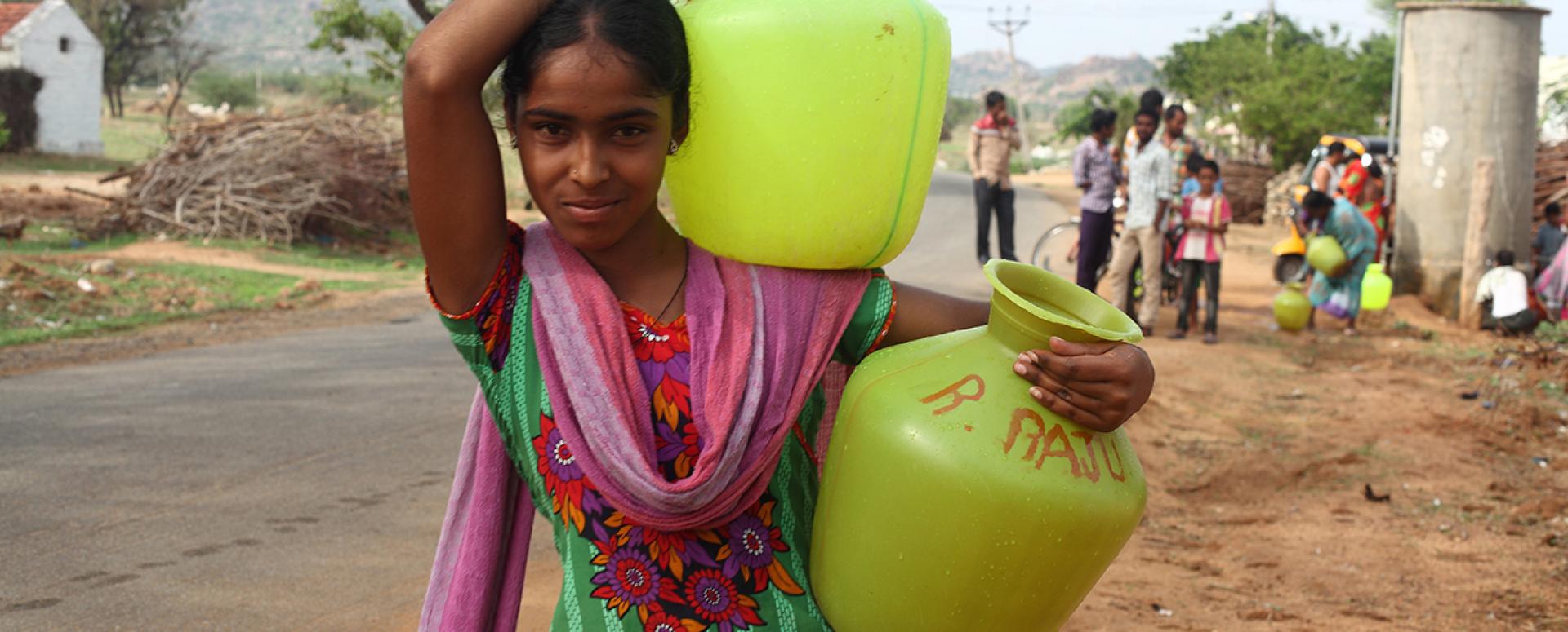 Young Indian woman carrying water